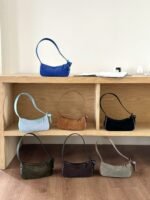 Nodo underarm bag color display on shelf - 7 colors in stock